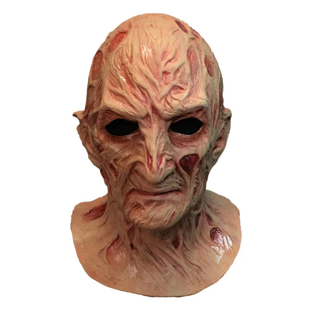 A Nightmare on Elm Street Dream Master Freddy Krueger Deluxe Costume Mask Features a latex full‑coverage sculpt with heavily burned, blistered skin textures, deep scar grooves, and warped facial contours, finished in mottled flesh tones with dark red shading to emphasize rot and damage and distortion that reflects Freddy’s supernatural decay, front view