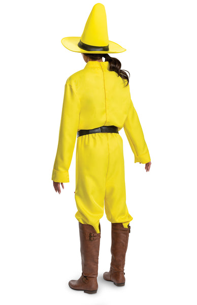 Back of woman in the Adults Curious George Person In The Yellow Hat Costume featuring a bright yellow long‑sleeve shirt styled with a pointed collar and a clip-on tie printed with bold black polka dots for a clean, character‑accurate look. The costume includes matching yellow pants with a relaxed fit, a wide black belt, and a tall structured yellow hat with a wide brim and black band that completes the instantly recognizable silhouette.