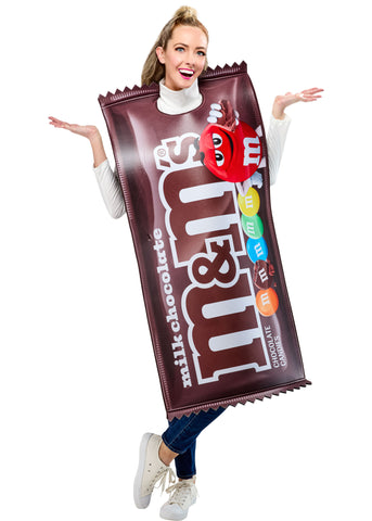 Woman posing in the Adults Milk Chocolate M&M's Costume Featuring a foam-backed tunic costume designed to resemble a milk chocolate M&M’s candy package, with a rich brown wrapper print, large white m&m’s branding across the front, printed colorful candy pieces along the side, jagged wrapper-edge detailing at the top and bottom, and an open, sleeveless design with side ties for an adjustable and comfortable fit over everyday clothing.