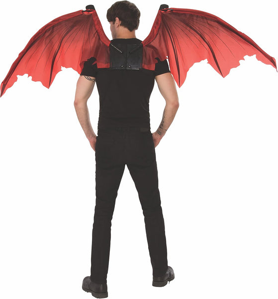 Back of man wearing the Green Mechanical Dragon Wings which feature a large pair of articulated wings constructed with red fabric panels stretched between structured internal supports, creating a realistic wing silhouette with visible vein‑like patterning throughout. The wings are connected to a central mechanical harness unit worn on the back, complete with visible hinge joints and attachment points; controlled by hand‑held pull loops allowing the wings to expand