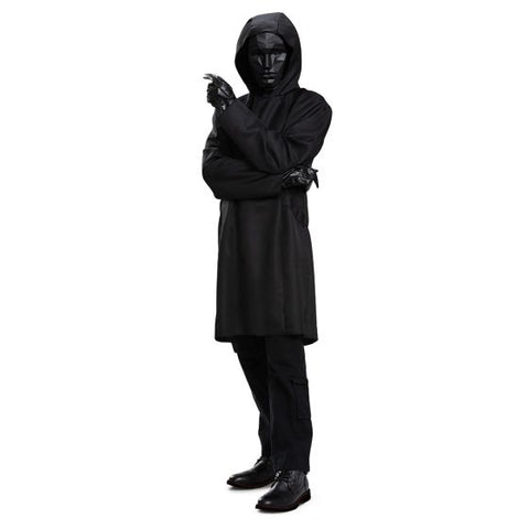Man posing in the Adults Squid Games Deluxe Front Man Costume Featuring a black hooded jacket with a long, straight silhouette and an attached hood, this costume includes a pair of black gloves with a smooth, faux leather appearance and a molded black mask designed with angular, faceted geometric detailing across the surface. The mask includes defined eye openings and is secured with an elastic strap.