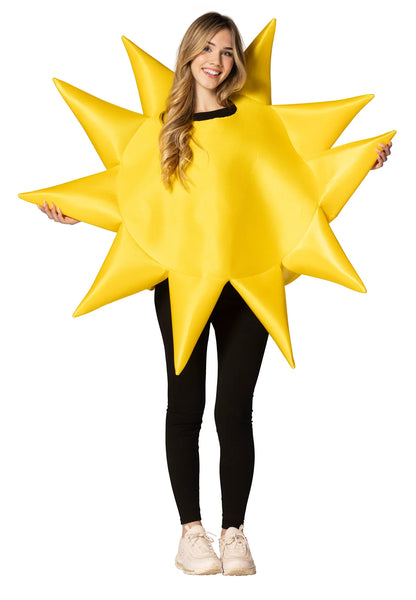 Woman in the Adults Sunny Day Giant Yellow Sun Costume Featuring a bright yellow polyfoam tunic designed in a circular sun shape with a smooth fabric surface and dimensional structure. The costume includes multiple pointed rays extending outward around the perimeter, along with a central round panel and side openings for arms. 