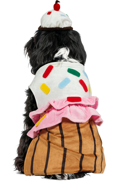 Back of Shih Tzu wearing the Pets Cute Cupcake Costume featuring a sweet, dessert‑inspired two‑piece outfit with a soft plush body designed to resemble a cupcake base in rich golden‑brown tones with vertical liner striping; topped with a layered “frosting” section made from fluffy white and pink fabric, decorated with colorful sprinkle accents in red, yellow, blue, and green. The look is completed with a matching cupcake headpiece topped with a red pom‑pom cherry detail, adding the perfect finishing touch 