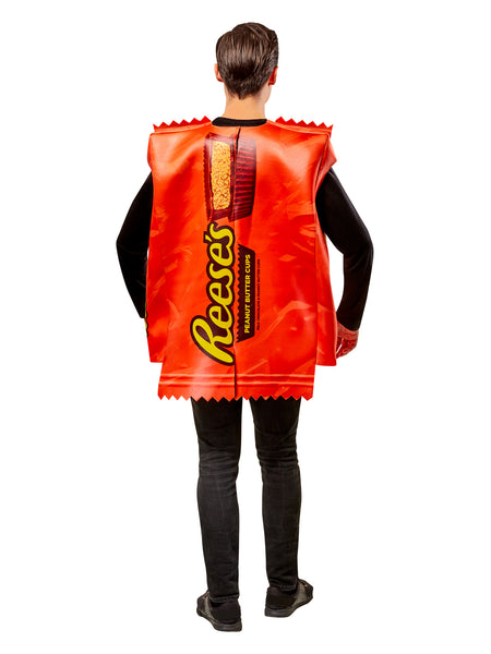 Back view of a Man in Adults Reese's Peanut Butter Cup Candy Costume featuring a bold, oversized tunic designed to resemble a classic Reese’s wrapper, printed in vibrant orange with large yellow “Reese’s” lettering and a detailed image of a sliced peanut butter cup at the top; styled with crimped “wrapper” edges at the neckline and hem for a realistic candy‑bar effect. The lightweight, sleeveless design slips easily over clothing, creating a full‑body candy package silhouette that’s instantly recognizable 
