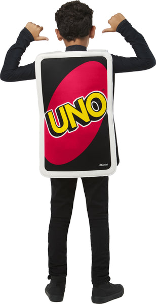 Back view of a boy in the Kids Mattel Uno Card Game Draw Four Card Costume featuring a tunic designed to look like the iconic UNO Draw Four card, with a black background bordered in white and a large white oval at the center; the card face is printed with four colorful card symbols in blue, green, yellow, and red, along with the “+4” markings in the corners, recreating the instantly recognizable look straight from the game