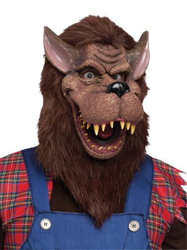 Big Bad Wolf Costume Mask features a full‑face molded mask designed in a rich brown faux‑fur finish, sculpted with exaggerated wolf features including a long protruding snout, wide open mouth, and sharp tooth detailing; the face includes defined wrinkle lines for added character. The mask is finished with shaggy brown faux‑fur hair around the sides and back, creating a full, wild silhouette that frames the head