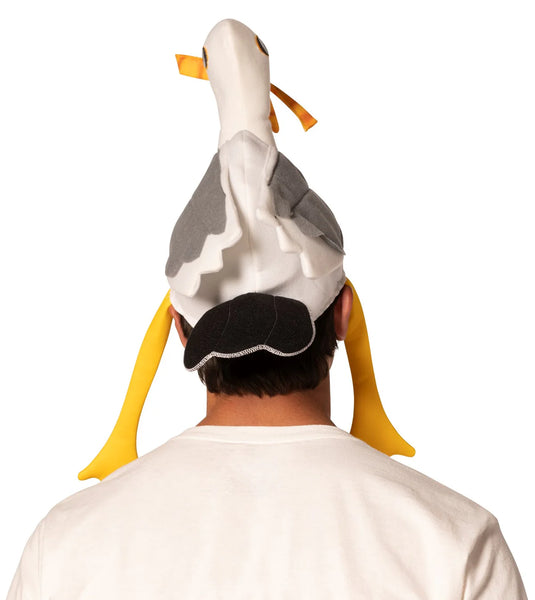 Back view of Man modeling the Boardwalk French Fry Thief Seagull Hat Featuring a foam headpiece shaped like a seagull with a white body, gray wing panels on each side, and a sculpted head with a long neck, detailed with a yellow beak holding soft 3D French fries, round printed eyes, and dangling yellow legs that hang down along the sides for added movement and dimension.