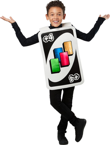 Boy posing in the Kids Mattel Uno Card Game Draw Four Card Costume featuring a tunic designed to look like the iconic UNO Draw Four card, with a black background bordered in white and a large white oval at the center; the card face is printed with four colorful card symbols in blue, green, yellow, and red, along with the “+4” markings in the corners, recreating the instantly recognizable look straight from the game