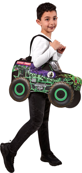 Boy posing in the Toddlers Monster Jam Grave Digger Monster Truck Driver Costume featuring a padded, wearable truck body designed in the shape of the iconic Grave Digger, worn with shoulder straps for a fun “ride‑on” illusion; styled in signature black and purple with bold green flames, skull graphics, and detailed printed panels. Includes oversized foam wheels with green rims, “Monster Jam”/“Grave Digger” branding, and a front windshield graphic for a complete 3D monster truck look