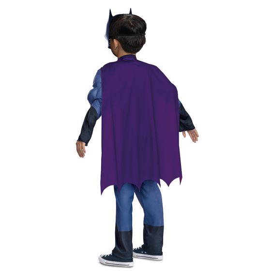 Back of Boys DC Universe Batwheels Classic Batman Muscle Costume Featuring a full-length jumpsuit in shades of blue with printed muscle detailing in the torso and arms, this costume includes a yellow utility belt graphic at the waist and a black bat emblem on the chest. The set also includes a detachable purple cape with a pointed hem and a molded character mask designed with bat ears, eye openings, and a smooth contoured surface.