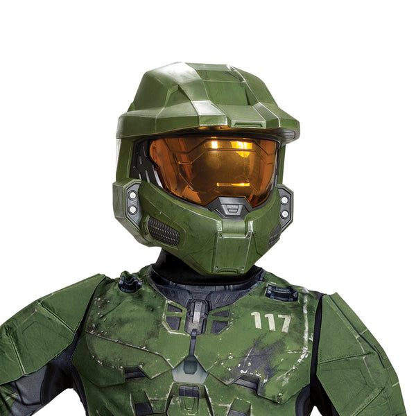 Close up of Boy posing in the Boys Xbox Halo Master Chief Costume Featuring a full-length jumpsuit printed with green and black armor panel graphics, this costume includes detailed design elements such as chest plating, joint sections, and battle-style markings throughout the front and back. The outfit is paired with a molded green mask featuring angular panel lines and a gold-tinted visor, with an elastic strap at the back for secure positioning.