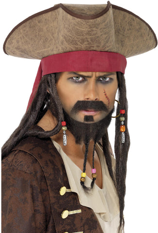 A man wearing the Brown Pirate Hat with Dreadlock Hair, featuring a large brown tricorn hat, a red headband, long dark brown dreadlocks with beads