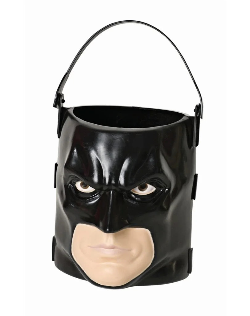 DC Universe Batman Trick or Treat Candy Pail Bucket Featuring a molded plastic candy pail designed in the shape of Batman's cowl and face, with a black exterior, sculpted facial details, painted eyes, a flesh-tone lower face section, and an open-top bucket design. The pail includes an attached black carry handle secured to each side, creating a functional trick-or-treat container