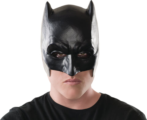 Man in the DC Universe Batman v Superman: Dawn of Justice Half Mask Featuring a black molded half mask with a matte finish, designed with sculpted brow lines, deep-set eye openings, and a contoured nose bridge, extending upward into two pointed bat ears, with a snug face-hugging shape that covers the upper half of the face while leaving the mouth and chin exposed.