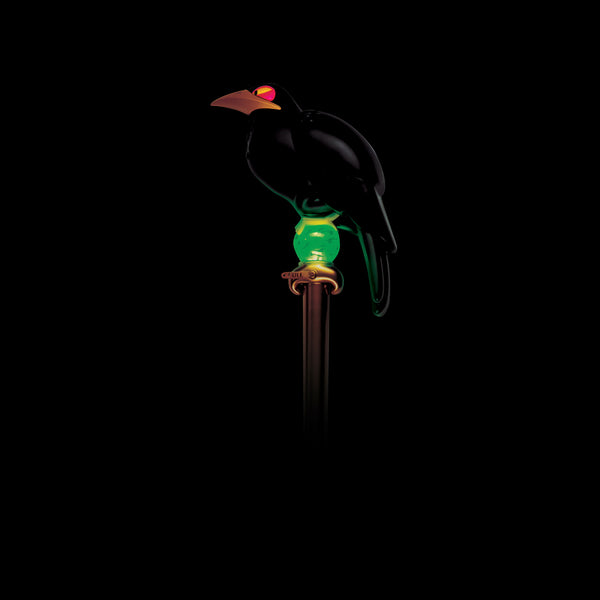 Light up view of Disney's Sleeping Beauty Maleficent Staff Costume Prop Accessory Featuring a long straight staff with a metallic gold shaft, this accessory is topped with a molded black raven perched above a spherical green orb detail that lights up. The raven design includes a curved beak and folded wings with sculpted feather detailing, while the translucent green orb beneath it features a marbled effect and internal illumination, set into a gold collar that connects to the staff.