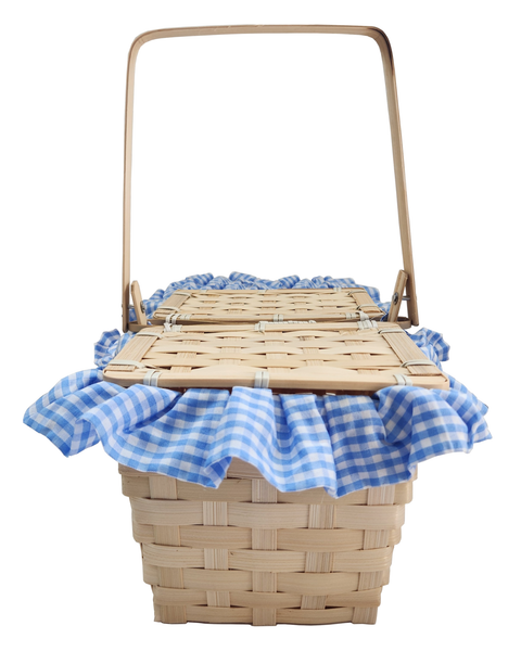 A natural woven basket with a tall handle, lined with a blue and white gingham fabric trim