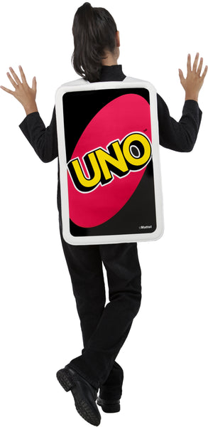 Back view of a girl in the Kids Mattel Uno Card Game Draw Four Card Costume featuring a tunic designed to look like the iconic UNO Draw Four card, with a black background bordered in white and a large white oval at the center; the card face is printed with four colorful card symbols in blue, green, yellow, and red, along with the “+4” markings in the corners, recreating the instantly recognizable look straight from the game