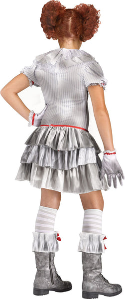 Back of Girl wearing the Carnevil Clown Costume featuring a ruffled dress designed with printed pin‑stripe fabric and layered tiered skirt panels. The dress is styled with a mixed‑material collar, short puff sleeves with ruffled trim, and bold red ribbon accents. Three large red pom‑pom details run down the front, adding classic clown styling, The costume includes matching gloves, knee ‑high socks, and ruffle boot cuffs with red bow accents.