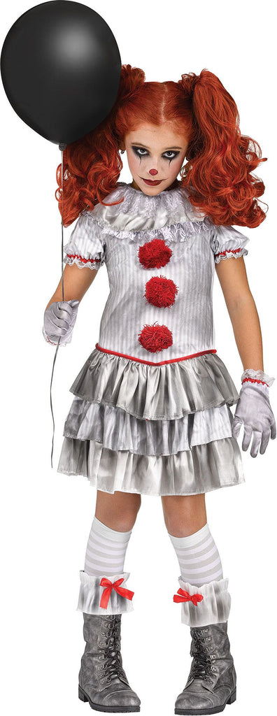 Girl wearing the Carnevil Clown Costume featuring a ruffled dress designed with printed pin‑stripe fabric and layered tiered skirt panels. The dress is styled with a mixed‑material collar, short puff sleeves with ruffled trim, and bold red ribbon accents. Three large red pom‑pom details run down the front, adding classic clown styling, The costume includes matching gloves, knee ‑high socks, and ruffle boot cuffs with red bow accents.