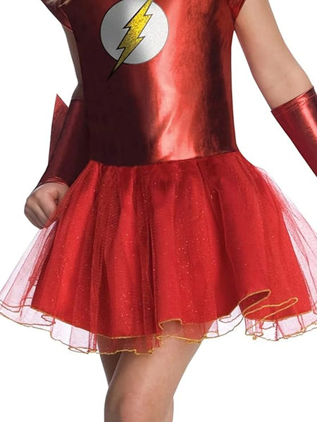 Close of of the bottom of the Girls DC Universe The Flash Tutu Costume Dress which features a vibrant red sleeveless dress styled with a fitted metallic‑red bodice and a layered red tutu skirt trimmed with subtle gold glitter accents; the chest is decorated with The Flash’s iconic lightning bolt emblem set inside a white circle for instant superhero recognition. 