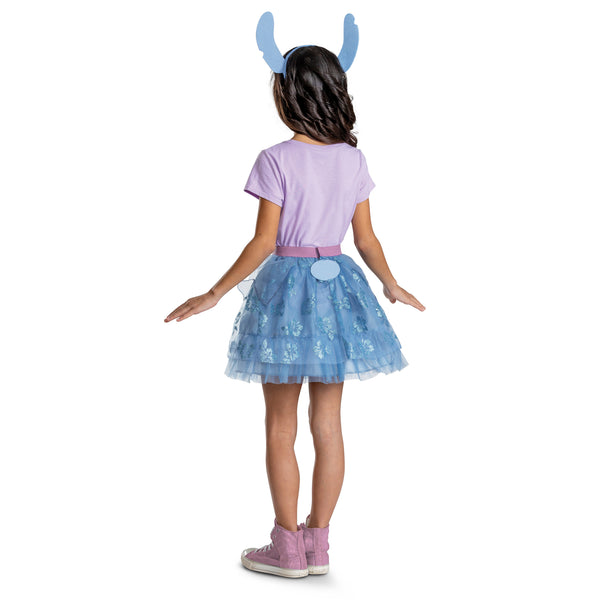Back of Girl posing in the Girls Disney's Lilo & Stitch Tutu and Headband Costume Accessory Kit featuring a two‑piece, including a layered blue tulle tutu skirt and a coordinating headband with oversized Stitch ears. The skirt is designed with multiple ruffled tiers of soft mesh fabric, accented with printed floral patterns and a glittery purple elastic waistband. A small Stitch character medallion sits at the front of the waistband. The headband features large blue ears with pink inner panels.