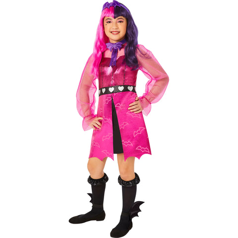 Girl posing in the Girls Monster High Draculara Costume Featuring a pink dress with a metallic sheen and bat print pattern on the skirt, designed with a fitted bodice, sheer long sleeves, and a black waistband accented with heart details, paired with a bat-shaped bow tie, a matching headpiece with bat-inspired design, black knee-high socks, and ankle accessories shaped like bat wings.