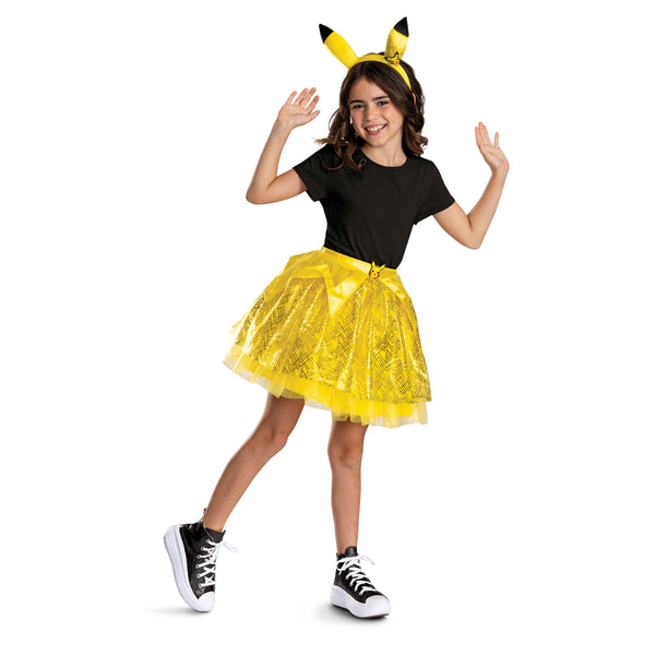 Girl posing in the Nintendo Pokemon Pikachu Tutu and Headband Kit featuring a bright two‑piece set that includes a layered yellow tutu skirt and a matching headband with Pikachu ears. The tutu is designed with multiple layers of soft yellow mesh and tulle, accented with gold geometric patterns and subtle sparkle details, along with a satin waistband finished with a small Pikachu character medallion at the front. The headband features tall, upright Pikachu ears in vibrant yellow with black tips and Pikachu