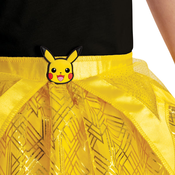 Girls Nintendo Pokemon Pikachu Tutu and Headband Kit featuring a bright two‑piece set that includes a layered yellow tutu skirt and a matching headband with Pikachu ears. The tutu is designed with multiple layers of soft yellow mesh and tulle, accented with gold geometric patterns and subtle sparkle details, along with a satin waistband finished with a small Pikachu character medallion at the front. The headband features tall, upright Pikachu ears in vibrant yellow with black tips and Pikachu
