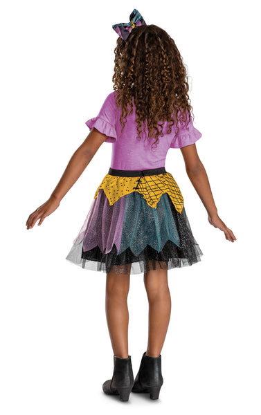 Back of Girls The Nightmare Before Christmas Sally Tutu and Headband Costume Accessory Kit Features a two‑piece set inspired by Sally, including a layered tutu skirt and coordinating headband with bow detail. The skirt is designed with mixed‑color panels of black, teal, purple, and yellow mesh fabric, arranged in uneven, patchwork‑style layers with a light shimmer finish. The waistband is finished with a sparkled black band and a small Sally character cameo at the front. The headband includes a matching bow
