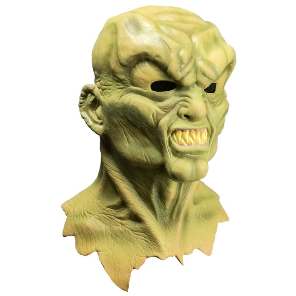 Goosebumps The Haunted Mask Costume Mask features a sickly yellow‑green latex finish, darker olive shading for an aged, cursed look, deep hollow black eye openings, exaggerated cheek contours, a stretched twisted smile with shadowed wrinkles, flared nostrils, and smooth rounded edges, right profile