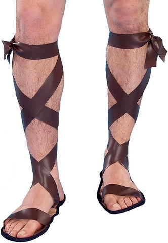 Man wearing Halloween Costume Sandals Roman Costume Sandals which feature a pair of brown faux‑leather sandal covers designed with long wraparound straps that crisscross up the calves, recreating the classic lace‑up look of ancient Roman and Greek footwear; styled with open‑toe sandal bases and a slim sole, finished with tie closures at the top of the calf that complete the authentic, old‑world silhouette