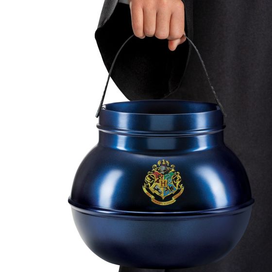 Child holding the Harry Potter Jumbo Hogwarts Cauldron Trick or Treat Pail Bucket Featuring a rounded cauldron-style pail in a metallic blue finish, this bucket includes a wide open top and a curved black handle attached at both sides. The front displays a Hogwarts crest graphic with multicolored detailing, while the handle features embossed text reading Happy Halloween