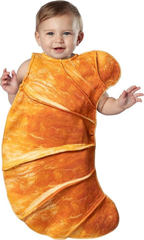 Baby in Infants Cute Croissant Bunting Costume Featuring a sleeveless baby bunting designed in the shape of a croissant with a soft, rounded silhouette that wraps around the body. The front displays a photorealistic baked pastry print in golden brown tones with layered folds
