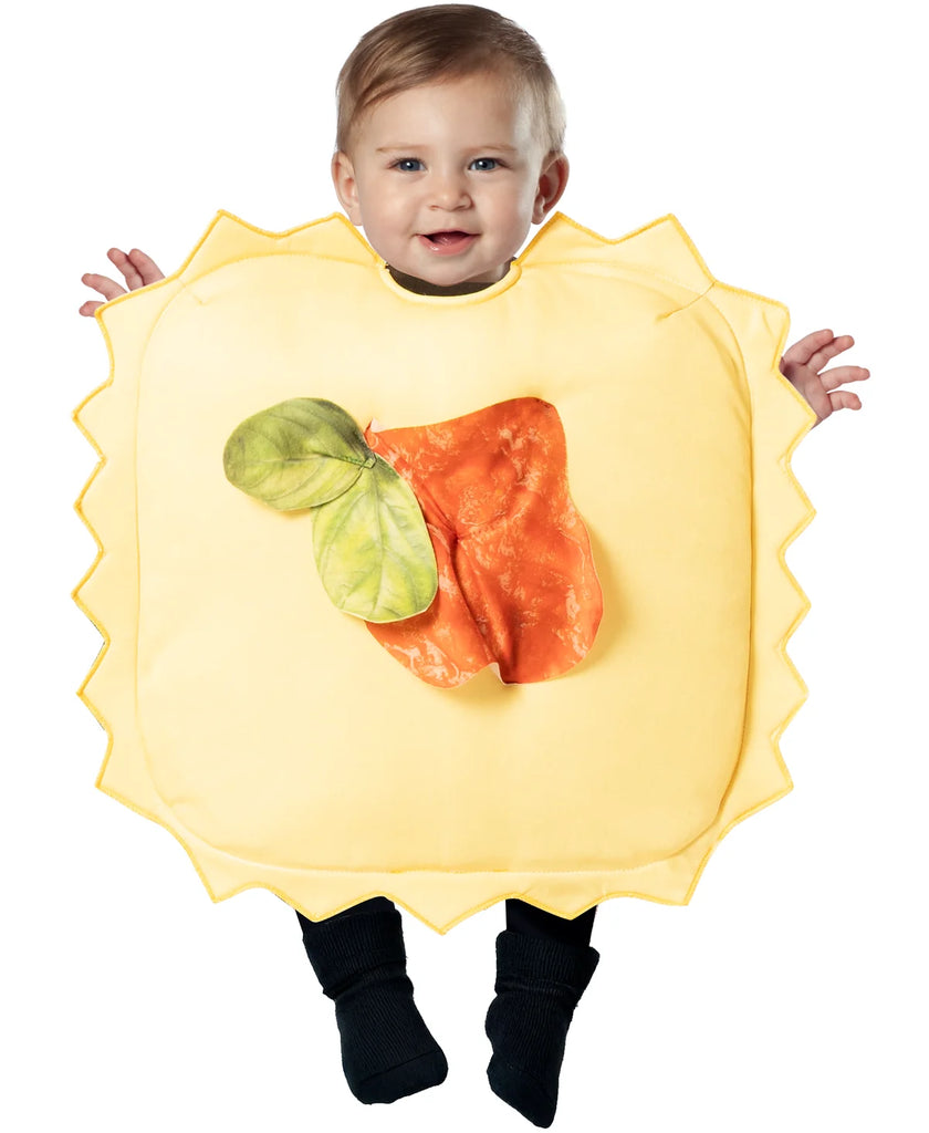 Toddler in the Little Ravioli Pasta Bunting costume Featuring a soft infant bunting costume designed to resemble a ravioli pasta square, with a light yellow fabric body, scalloped edges around the perimeter to mimic pasta crimping, a rounded neck opening, and a dimensional red sauce dollop accented with green basil leaves attached to the front center. The costume has a cushioned square shape with clean edge binding and a simple slip-on design.