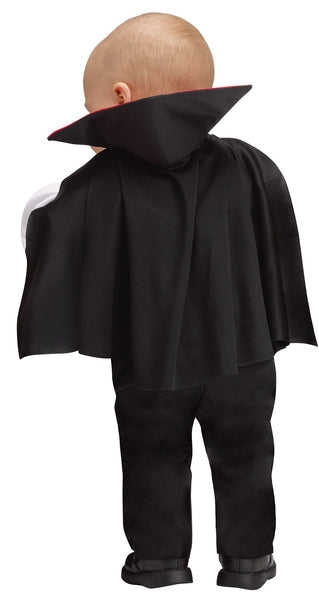 Back of Toddler in the Infants Toddlers Baby Dracula Vampire Costume featuring a soft one‑piece outfit styled to resemble a classic vampire suit, designed with black pants and an attached white shirt front layered under a gray vest with gold button accents and a black bow tie. The costume includes a dramatic attached cape with a high stand‑up collar lined in bright red satin, creating that instantly recognizable Dracula silhouette while remaining lightweight and comfortable for little ones.