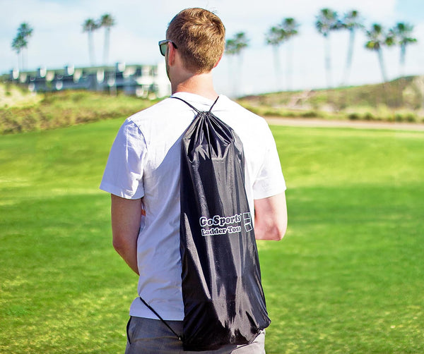 Person wearing a GoSports ultra portable carrying bag on a golf course
