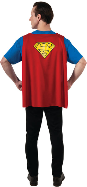 Man in DC Universe Superman Costume Shirt with Cape featuring a comfortable blue short‑sleeve T‑shirt printed with a bold comic‑style Superman design including the iconic red‑and‑yellow “S” shield emblem prominently displayed on the chest, along with printed muscle shading and a bright yellow utility belt graphic across the waist; includes an attached red cape that drapes down the back and features a large Superman emblem printed between the shoulders for a fully recognizable hero silhouette from both front