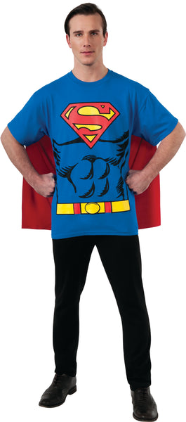 Man in DC Universe Superman Costume Shirt with Cape featuring a comfortable blue short‑sleeve T‑shirt printed with a bold comic‑style Superman design including the iconic red‑and‑yellow “S” shield emblem prominently displayed on the chest, along with printed muscle shading and a bright yellow utility belt graphic across the waist; includes an attached red cape that drapes down the back and features a large Superman emblem printed between the shoulders for a fully recognizable hero silhouette from both front