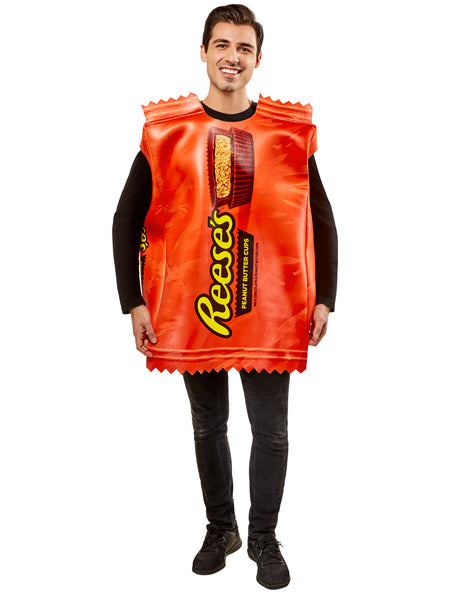 Man in Adults Reese's Peanut Butter Cup Candy Costume featuring a bold, oversized tunic designed to resemble a classic Reese’s wrapper, printed in vibrant orange with large yellow “Reese’s” lettering and a detailed image of a sliced peanut butter cup at the top; styled with crimped “wrapper” edges at the neckline and hem for a realistic candy‑bar effect. The lightweight, sleeveless design slips easily over clothing, creating a full‑body candy package silhouette that’s instantly recognizable 