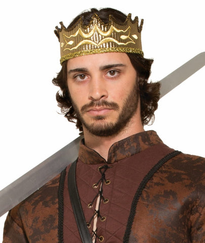 Man wearing the Medieval Fantasy King Crown Costume Accessory which features a  gold‑tone crown with an openwork design, detailed with raised wave‑like patterns and textured cutout accents around the band; finished with a slightly uneven, hand‑forged look that gives the crown an authentic medieval feel, complete with a subtle glittering trim along the base that catches the light without overpowering the design