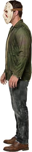 Side view of Man posing in the Friday the 13th Jason Voorhees Costume Featuring and off-white hockey-style mask with cutout eye openings, multiple ventilation holes, red painted accent markings, and an adjustable brown head strap, along with a printed jumpsuit designed to look like a distressed olive-green jacket layered over a worn shirt and attached matching gray printed pants with weathered detailing, torn-effect artwork, and an aged appearance