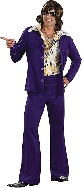 Man posing in the Mens Purple Leisure Suit Costume which includes a bold, retro two‑piece set that includes a deep purple jacket and matching flared pants; the jacket is designed with a wide notched collar, front button closure, and flap chest pockets, creating a classic 1970s leisure‑suit silhouette, while the pants are tailored through the hips and thighs before flaring dramatically at the hem for that unmistakable disco‑era shape