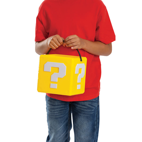 Child holding the Nintendo Super Mario Mystery Block Box Trick or Treat Pail Bucket features a yellow plastic bucket designed in the shape of the iconic Super Mario “?” mystery block, complete with raised white question mark symbols on multiple sides and molded corner details for an authentic game‑inspired look.