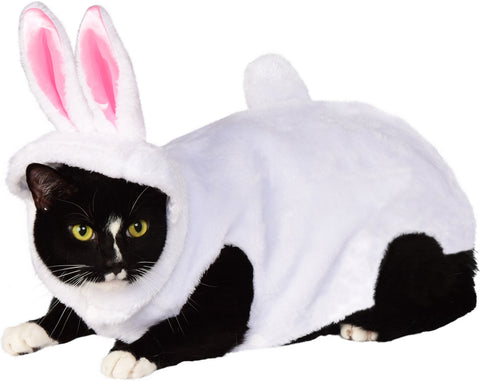 Cat wearing the Pets Bunny Rabbit Costume featuring a soft white plush one‑piece outfit that covers the body with a rounded, cozy silhouette; includes an attached hood trimmed in white faux fur and topped with tall upright bunny ears lined in light pink, along with a small, rounded bunny tail 