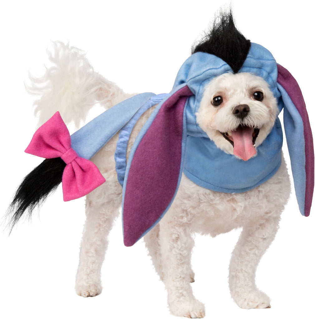 A Small dog wearing Pets Disney Winnie the Pooh Eeyore Costume Accessory Kit featuring a soft fabric headpiece designed to resemble Eeyore’s gentle donkey face, complete with long floppy ears, subtle stitched facial details, and a muted blue‑gray color palette that captures the classic character look; paired with a lightweight attached tail accessory finished with Eeyore’s signature pink bow