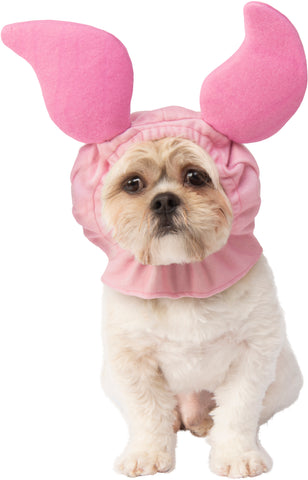 A small dog wearing the Pets Disney Winnie the Pooh Piglet Headpiece Costume Accessory featuring a soft pink fabric hood designed to resemble Piglet’s head, complete with oversized upright ears