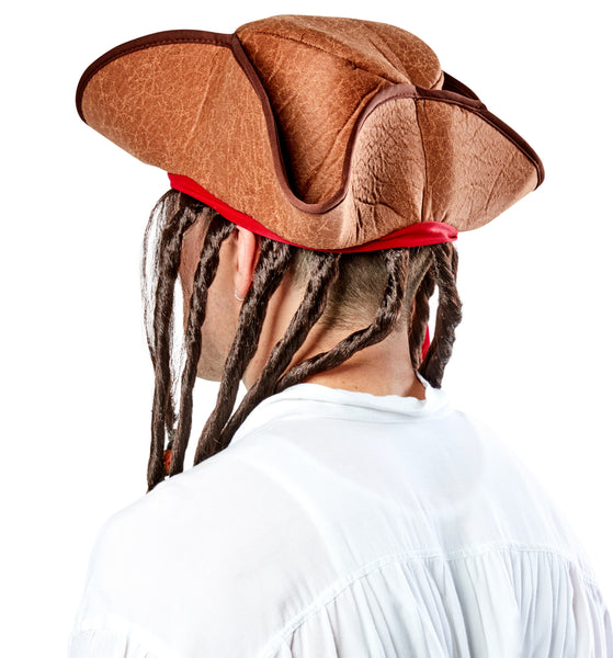 Back view of a man wearing the Pirate Hat with Dreads Costume Hat featuring a weathered brown tricorn‑style pirate hat with a textured, leather‑look finish and stitched edging along the brim; accented with a wrapped red fabric band tied around the hat, from which long dark brown faux dreadlocks hang down on both sides; several of the dreadlocks are decorated with small bead details in metallic silver and amber tones