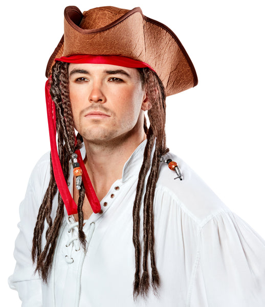 Man modeling Pirate Hat with Dreads Costume Hat featuring a weathered brown tricorn‑style pirate hat with a textured, leather‑look finish and stitched edging along the brim; accented with a wrapped red fabric band tied around the hat, from which long dark brown faux dreadlocks hang down on both sides; several of the dreadlocks are decorated with small bead details in metallic silver and amber tones, side profile