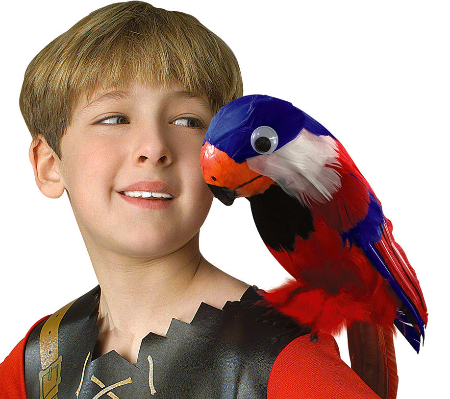 Boy posing with the Pirate's Feathered Parrot Costume Prop featuring a brightly colored faux‑parrot designed to perch realistically on the shoulder, covered in layered red, blue, white, and black synthetic feathers that create a vivid tropical look. The parrot includes a sculpted orange‑and‑black beak, a rounded head with a glossy eye detail, and a curved tail that drapes naturally down the back, giving the prop a lifelike silhouette straight out of classic pirate imagery