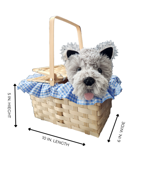 Measurement view of Boots and Brother's Puppy in a Basket featuring a woven natural wood basket with a handle, lined with a blue and white gingham fabric ruffle, holding a plush dog toy with gray and white fur, black ears, and a pink tongue